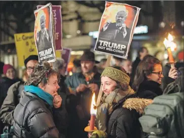  ?? Salvatore Di Nolfi EPA/Shuttersto­ck ?? PROTESTERS in Geneva make their feelings known about President Trump. Diplomats wonder whether Trump will soft-sell his populist rhetoric at the World Economic Forum or strike a confrontat­ional tone.