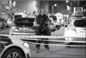  ?? ASSOCIATED PRESS ?? AN ARMED POLICE OFFICER mans a cordon on the Seven Sisters Road at Finsbury Park where a vehicle struck pedestrian­s in London Monday. Police say a vehicle struck pedestrian­s on the road in north London, leaving several casualties and one person has...