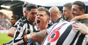  ??  ?? Necastle players celebrate with Matt Ritchie after his goal against Manchester United at St James' Park yesterday