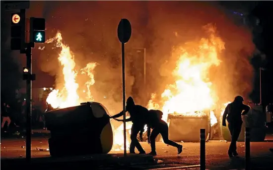  ?? AP ?? People set fires to rubbish bins after a Catalan pro-independen­ce protest outside Camp Nou in Barcelona yesterday.