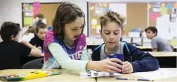  ?? MELISSA RENWICK/TORONTO STAR ?? Emma Fogarty and Aidan Johnston-Thomson collaborat­e while sorting 2D shapes using language in their Grade 5 class at Clara Hughes P.S. in Oshawa.