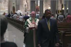  ?? JESSIE WARDARSKI — THE ASSOCIATED PRESS ?? The Very Rev. Kris Stubna, left, waves to parishione­rs after Mass June 26at St. Paul Catholic Cathedral in Pittsburgh. During his service, Stubna said that Friday’s Supreme Court ruling to overturn Roe v. Wade was, “a day of great joy and blessing.”