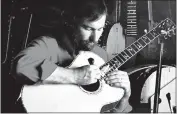  ?? SUBMITTED PHOTO ?? Larry Sifel working on a guitar in an undated photograph.