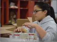  ?? MEDIANEWS GROUP FILE PHOTO ?? Members of student government from Pottstown High School have helped pack the more than 200 boxes of food every year since Operation Holiday began.