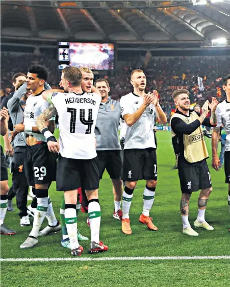  ??  ?? Job done: Liverpool players celebrate after surviving a nervous finish to seal their place in the final; and (right) Jurgen Klopp savours the moment with Roberto Firmino (left) and Danny Ings