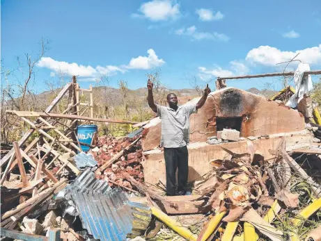  ?? Picture: AFP ?? A Haiti man shows his despair while standing in the remains of his house shattered by Hurricane Matthew