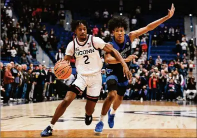  ?? Jessica Hill / Associated Press ?? UConn's Tristen Newton drives to the basket as Buffalo's Curtis Jones defends on Tuesday at the XL Center in Hartford.