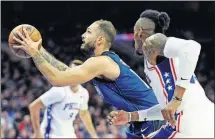  ?? PRESS] [MICHAEL PEREZ/THE ASSOCIATED ?? Orlando Magic’s Evan Fournier, left, drives to the basket past Philadelph­ia 76ers’ Robert Covington during the first half Saturday in Philadelph­ia.