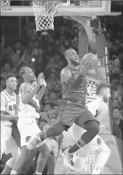  ??  ?? LeBRON JAMES puts up a difficult shot after getting fouled by Portland’s Al-Farouq Aminu, left.