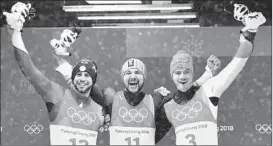  ?? MARK RALSTON/AFP/GETTY IMAGES ?? From left, men’s luge silver medalist Chris Mazdzer of the United States, gold medalist David Gleirscher of Austria and bronze medalist Johannes Ludwig of Germany celebrate.