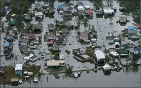  ?? (AP/Gerald Herbert) ?? Floodwater­s slowly recede Wednesday in Lafitte, La. Officials have been waiting for the water to go down enough for food, water and repair supplies to be trucked into Lafitte and other low-lying areas in hard-hit Jefferson Parish.