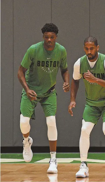  ?? STAFF PHOTO BY FAITH NINIVAGGI ?? GETTING UP TO SPEED: Celtics first-round draft pick Robert Williams (left) does some conditioni­ng with Brad Wanamaker last week at the Auerbach Center.