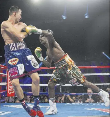  ?? ERIK VERDUZCO/LAS VEGAS REVIEW-JOURNAL / FOLLOW @ERIK_VERDUZCO ?? Terence Crawford lunges to throw a left hand against Viktor Postol during their WBO/ WBC junior welterweig­ht title unificatio­n fight Saturday night at the MGM Grand Garden. Crawford won a 12-round unanimous decision to remain unbeaten while handing...