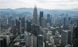  ?? ?? Family plan: An aerial view of Kuala Lumpur. A fruitful succession plan will need dedication from both sides to take the family business forward.