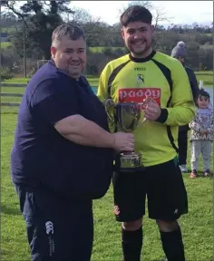  ??  ?? Conor Kinsella of Gorey Rangers accepts the Division 3 cup from Phil O’Brien of the Wexford Football League.