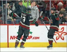  ?? AP-Ross D. Franklin ?? Coyotes defenseman Alex Goligoski celebrates his goal against the Devils with Coyotes right wing Vinnie Hinostroza, right, on Saturday