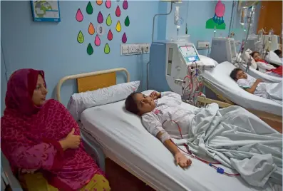  ?? AFP ?? Patient Maria is watched over by her mother as she receives kidney dialysis treatment at the Sindh Institute of Urology and Transplant­ation (SIUT) in Karachi. Dr Adibul Rizvi provides free medical care to hundreds of thousands of people each year, providing a much-needed alternativ­e to Pakistan’s public health sector, which critics dismiss as chaotic, corrupt and vastly under-resourced. —