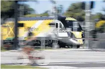  ?? BRYNN ANDERSON/ASSOCIATED PRESS ?? A Brightline passenger train carries Richard Branson in South Florida after his announceme­nt of the Virgin brand.