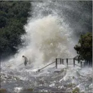  ?? DAVID GRUNFELD — NOLA.COM THE TIMES-PICAYUNE VIA AP ?? With a rising tide, strong southerly winds from Tropical Depression Cindy lash the lakefront Thursday in Mandeville, La.