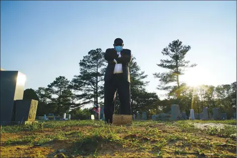  ?? (AP/Allen G. Breed) ?? Mortician Shawn Troy stands May 23 at the grave of his father, William Penn Troy Sr., at Hillcrest Cemetery outside Mullins, S.C. The elder Troy, who developed the cemetery, died of covid-19 in August 2020, one of many Black funeral directors to succumb during the pandemic.