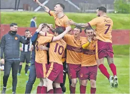  ?? ?? Delight Lewis Anderson is mobbed after netting Whitburn’s fourth goal