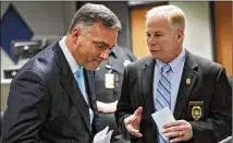  ?? BOB ANDRES/AJC 2019 ?? John Melvin (left) was executive director of the GBI, working under Michael Register as second-in-command. In a statement from the agency, no reason was given for Melvin’s departure.