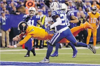  ??  ?? Broncos quarterbac­k Brock Osweiler eludes Colts defenders to dive in for a touchdown on Thursday.