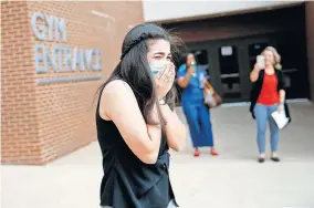  ?? [BRYAN TERRY/ THE OKLAHOMAN] ?? Edmond Memorial senior Gabriela Pinto-Ordonez is surprised to learn that she is the recipient of the Positive Energy Scholarshi­p from OGE Energy Corp. Foundation as she walks out of Edmond Memorial High School on Tuesday.