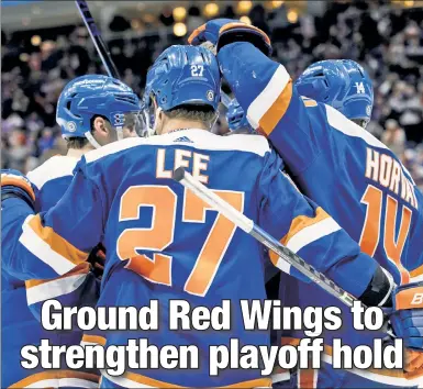  ?? Michelle Farsi ?? LITTLE BIT CLOSER NOW: Anders Lee and his Islanders teammates celebrate a goal Saturday during a 4-1 win over the Red Wings.