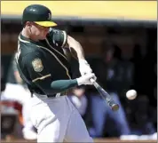  ?? AP photo ?? The Athletics’ Matt Chapman hits a tworun double during the third inning of Oakland’s 21-3 win over the Angels on Thursday.