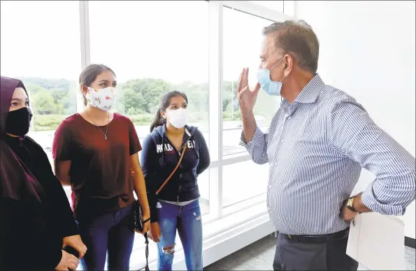  ?? Arnold Gold / Hearst Connecticu­t Media ?? From left, West Haven High School seniors Gozde Yildiz, Yaritza Magana and Briana Xolocotzi speak with Gov. Ned Lamont after a meeting at the school on Friday.