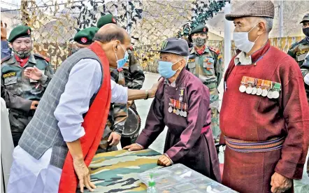  ?? — PTI ?? Defence minister Rajnath Singh interacts with veterans in Leh on Sunday.