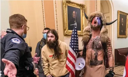  ?? Photograph: Manuel Balce Ceneta/AP ?? Donald Trump supporters, including Jacob Chansley, are confronted by US Capitol police officers on 6 January 2021 in Washington DC.