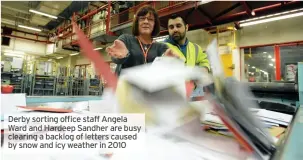  ?? ?? Derby sorting office staff Angela Ward and Hardeep Sandher are busy clearing a backlog of letters caused by snow and icy weather in 2010