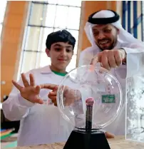  ??  ?? A kid and a Sewa staff member tinker with a plasma ball on display at the authority’s stand at the innovation event in Sharjah.