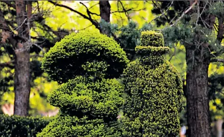  ?? DISPATCH FILE PHOTO ?? Topiary figures greet visitors to the Topiary Garden in a quiet neighborho­od Downtown.