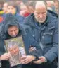  ?? AP ?? ■
Relatives of a Ukrainian plane crash victim at a memorial service outside of Kyiv.
