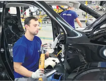  ?? JIANG XUEQING / CHINA DAILY ?? Employees at work at the Sino-Belarusian automaker BelGee on Aug 11. Located between Borisov and Zhodino of Belarus, the plant currently employs less than 1,000 people, and most of them are local residents.