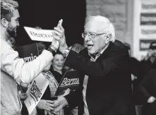  ?? Ruth Fremson / New York Times ?? Sen. Bernie Sanders greets voters at a town hall meeting Jan. 4 in Dubuque, Iowa. The poll has Sanders holding a slim lead there.