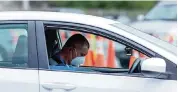  ?? DANIEL A. VARELA dvarela@miamiheral­d.com ?? A person waits to get vaccinated at Hard Rock Stadium in Miami Gardens on Monday. The site will no longer require appointmen­ts and has expanded COVID vaccine hours.