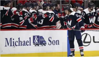  ?? (AP PHOTO/NICK WASS) ?? Washington Capitals left wing Sonny Milano (15) is congratula­ted for his goal against the Chicago Blackhawks during Saturday night’s game.