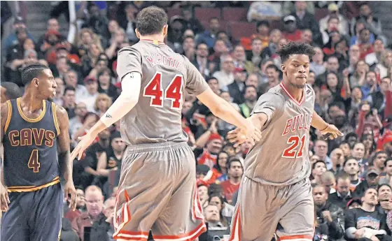  ??  ?? Bulls forward Jimmy Butler, right, and teammate Nikola Mirotic celebrate a basket during the second half at the United Center.