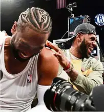  ?? — AFP ?? Goodbye friend: LeBron James of the LA Lakers (right) jokes with Dwyane Wade after the game against the Brooklyn Nets on Wednesday. It was Wade’s last NBA game before retirement.