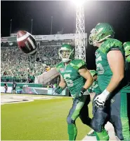  ?? MICHAEL BELL/Leader-Post ?? Roughrider­s receiver Rob Bagg, left, tosses the ball to an official after scoring a touchdown Saturday against Ottawa.