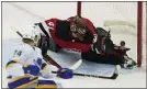  ?? JOHN MINCHILLO — THE ASSOCIATED PRESS ?? Buffalo’s Rasmus Asplund (74) scores on Devils goaltender Scott Wedgewood (41) during Tuesday night’s game.