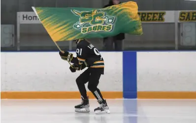  ?? CATHIE COWARD PHOTOS THE HAMILTON SPECTATOR ?? The Stoney Creek Sabres flag is flown around the ice before the team faces off.