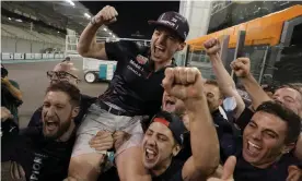  ?? Photograph: Hassan Ammar/AP ?? Max Verstappen celebrates with members of his team after winning the F1 championsh­ip in Abu Dhabi.