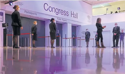  ?? BLOOMBERG ?? Workers stand outside the Congress Hall at the World Economic Forum in Davos, Switzerlan­d, last Friday.