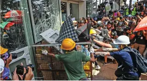  ??  ?? Seat of power: Activists attacking Hong Kong’s parliament on Monday