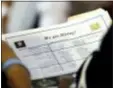  ?? ASSOCIATED PRESS FILE PHOTO ?? A job applicant looks at job listings for the Riverside Hotel at a job fair hosted by Job News South Florida, in Sunrise, Fla.